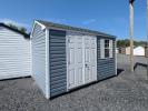 8x12 a-frame shed in twilight blue vinyl siding with white trim, doors, shutters, and a light grey shingle roof