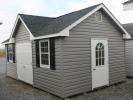 Pine Creek 12x20 Victorian Deluxe with Graphite Gray walls, White trim and Black Raised Panel shutters, and Charcoal shingles